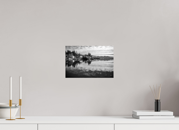 Serenity on the Water – Lake Tahoe in Black and White showcases tranquil reflections of cabins and pines.