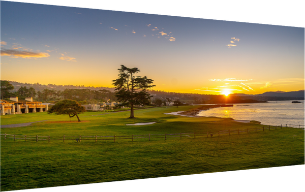 Breathtaking view of No. 18 at Pebble Beach at sunrise, showcasing vibrant greens and tranquil ocean hues.