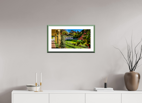 Scenic view from Pebble Beach promenade featuring the Champions of Pebble Beach monument and vibrant flowers.