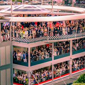 Elegant guests gather in the VIP at Monaco GP hospitality area, enjoying a stunning view near the start-finish line.