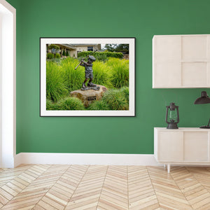 Statue of a boy golfer at Pebble Beach, capturing the spirit of "Just Like Dad" in a vibrant green setting.