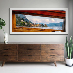 View from a boat window showcasing a lakeside village, capturing “A Window into Lake Como.” Perfect for home decor.